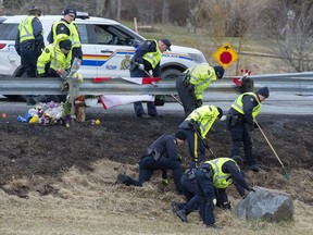 RCMP investigators search for evidence at the location where Const. Heidi Stevenson was killed along the highway in Shubenacadie, N.S. on Thursday, April 23, 2020. Court documents released today describe the violence a Nova Scotia mass killer inflicted on his father years before his rampage, as well as the gunman's growing paranoia before the outburst of shootings and killings.THE CANADIAN PRESS/Andrew Vaughan