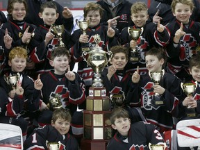 A Nepean Raiders team celebrates victory against the Gloucester Rangers during the Atom AAA championship game of the Bell Capital Cup at  Canadian Tire Centre on Dec. 31, 2018.