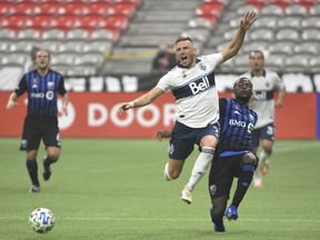 Whitecaps midfielder David Milinkovic (7) controls the ball against against Montreal Impact defender Zachary Brault-Guillard (15) in Vancouver on Sunday, Sept. 13, 2020.
