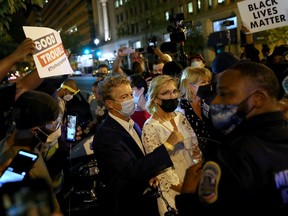 Protesters confront U.S. Sen. Rand Paul (R-KY) during a protest in Washington on Aug. 28, 2020.