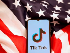 TikTok's logo is displayed on the smartphone while standing on the U.S. flag in this illustration picture taken, November 8, 2019.