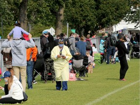 Hundreds of families with children waited in long, snaking lineups in the park outside Brewer Park COVID-19 testing centre Wednesday.