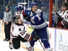 Blake Murray, right, of the Sudbury Wolves and Ben McFarlane of the Guelph Storm collide during an OHL game in January 2020.