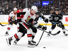 Rudolfs Balcers of the Ottawa Senators is checked by Sean Walker of the Los Angeles Kings during the first period at Staples Center on March 11, 2020 in Los Angeles, California.