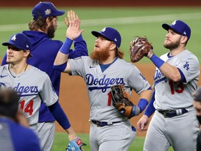 Justin Turner of the Los Angeles Dodgers celebrates with teammates after their 6-2 victory against the Tampa Bay Rays in Game 3 of the 2020 World Series at Globe Life Field in Arlington, Texas, on Oct. 23, 2020.