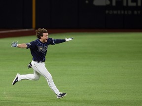 Tampa Bay Rays right fielder Brett Phillips (14) celebrates after driving in the winning run against the Los Angeles Dodgers during the ninth inning of game four of the 2020 World Series at Globe Life Field.