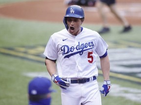Dodgers shortstop Corey Seager reacts after hitting a home run in the first inning against the Braves during Game 6 of the 2020 NLCS at Globe Life Field in Arlington, Texas, Saturday, Oct. 17, 2020.