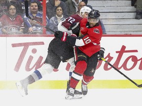 Anthony Duclair takes a shot with Joonas Donskoi of the Colorado Avalanche hanging off him during a Senators game last season. Duclair didn't get a qualifying offer from the Sens and is representing himself in free agency.