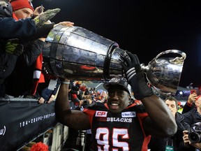 Moton Hopkins of the Ottawa Redblacks hoists the Grey Cup following his team's win over the Calgary Stampeders in Toronto in 2016.