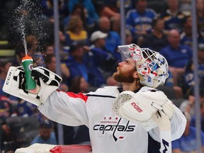 Goaltender Braden Holtby, then of the Washington Capitals, sprays water during a stoppage in play.