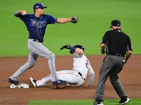 Houston Astros shortstop Carlos Correa (1) can not turn a double play over Tampa Bay Rays first baseman Ji-Man Choi (26) during the ninth inning during game four of the 2020 ALCS at Petco Park.