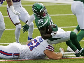 Running back Le'Veon Bell (right) is brought down by Buffalo Bills' Justin Zimmer during an NFL game Sept. 13. Bell was cut by the Jets on Tuesday and there is reportedly interest from the Bills, Chiefs and Dolphins.