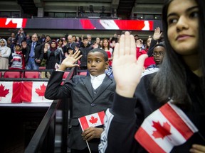 Immigration, Refugees and Citizenship Canada (IRCC) partnered with the Ottawa Senators in a special citizenship ceremony, where 20 families from 20 countries became Canadian citizens ahead of the hockey game between the Senators and the visiting Calgary Flames. Eleven-year-old Ahmed Mohammed holds his hand up while taking the oath during the ceremony Saturday Jan. 18, 2020