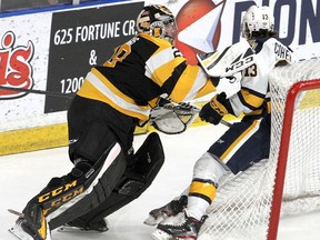 Kingston Frontenacs goalie Ryan Dugan bodychecks Erie Otters' forward Elias Cohen into the back of his net during an Ontario Hockey League game in Kingston on Jan. 3, 2020.