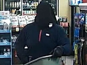 Man with piece of clothing on his head flees from a Manotick convenience store with a laundry basket full of cigarettes.