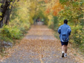 People were out enjoying the fall colours on a path alongside the Ottawa Riveron Friday October 16, 2020.