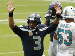 Russell Wilson #3 of the Seattle Seahawks celebrates after a touchdown against the Miami Dolphins during the fourth quarter at Hard Rock Stadium on October 04, 2020 in Miami Gardens, Florida.