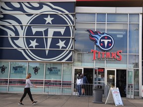 Titans fans make their way in and out of the Titans Team Store in Nashville on the originally scheduled day of a game between the Titans and Steelers, Oct. 4, 2020. The game was rescheduled to Oct. 25.