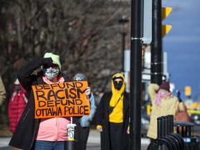Protesters for Indigenous and Black rights rallied outside Ottawa police headquarters on Elgin Street, Saturday, Nov. 21, 2020, where they demanded the release of 12 people arrested early Saturday morning after another protest was shut down.