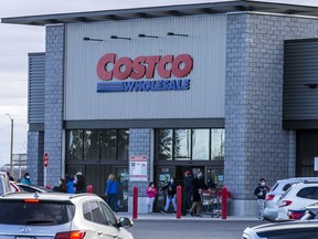 Shoppers head into and out of the Costco Gloucester location on Saturday.