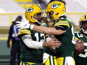 Robert Tonyan, right, of the Green Bay Packers hugs quarterback Aaron Rodgers after a touchdown during the second half of the game at Lambeau Field on Nov. 29, 2020 in Green Bay, Wis.