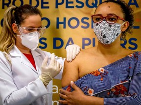 In this file photo taken on Aug. 8, 2020, health worker and volunteer Fabiana Souza receives a COVID-19 vaccine produced by Chinese company Sinovac Biotech at the Sao Lucas Hospital, in Porto Alegre, southern Brazil.