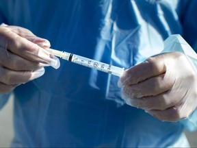 A needle and syringe used to administer the flu shot in shown in Virgil, Ont., Oct. 5, 2020. At this point during last year's flu season, Canada had already recorded 711 positive cases of influenza.
