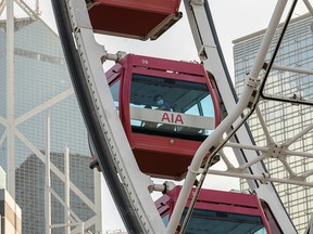 Visitors ride on the Hong Kong Observation Wheel in Hong Kong on November 19, 2020.