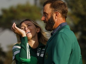 Dustin Johnson celebrates with partner Paulina Gretzky after winning The Masters. Reuters