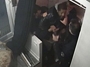 This video grab taken on November 27, 2020 from an AFP video shows CCTV camera footage of Michel Zecler being beaten up by police officers at the entrance of a music studio in Paris on November 21, 2020.