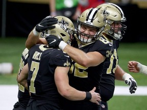 Saints' Taysom Hill (7) celebrates his touchdown with teammates Adam Trautman (82) against the Falcons at Mercedes-Benz Superdome in New Orleans, Nov. 22, 2020.