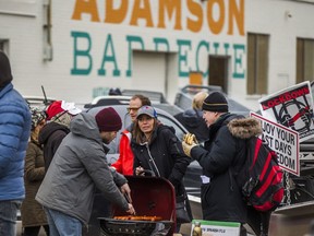 Supporters gather and barbecue outside Adamson Barbecue near Royal York and Gardiner Expressway in Toronto, Ont. on Friday.