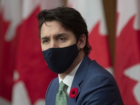 Prime Minister Justin Trudeau surveys the room as he listens to Canada's Chief Public Health Officer Theresa Tam speak during a news conference in Ottawa, Friday, November 6, 2020.