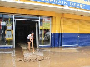 A resident cleans their shop in the aftermath of Typhoon Goni in Polangui, Philippines' Albay province on Monday, Nov. 2, 2020.