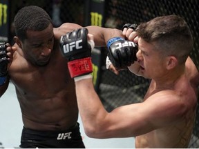 In this handout image provided by UFC, (L-R) Geoff Neal punches Stephen Thompson in a welterweight fight during the UFC Fight Night event at UFC APEX on December 19, 2020 in Las Vegas, Nevada.