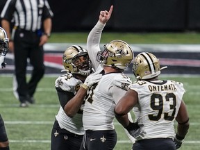 Saints defensive end Trey Hendrickson (91) celebrates his sack against the Falcons  with Cameron Jordan (94) and  David Onyemata during the second half at Mercedes-Benz Stadium on Sunday.