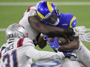 Cam Akers, right, of the Los Angeles Rams is tackled by Ja'Whaun Bentley of the New England Patriots during the first quarter in the game at SoFi Stadium on Dec. 10, 2020 in Inglewood, Calif.