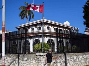 A man walks beside Canada's embassy in Havana, Cuba, April 17, 2018.
