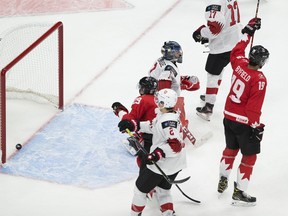 Canada's Quinton Byfield (19) celebrates his goal against Swiss goalie Noah Patenaude (1) during the IIHF world junior championships on Tuesday, Dec. 29, 2020.