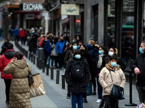 People queue to buy tickets at the popular "Dona Manolita" lottery outlet in Madrid on Dec. 18, 2020 for the famous "El Gordo" Christmas draw to be held on Dec. 22.