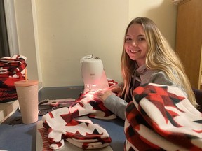 Emma Weller sews mittens in her residence room at Carleton University.