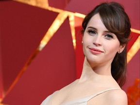 Felicity Jones poses as she arrives on the red carpet for the 89th Oscars on Feb. 26, 2017 in Hollywood.
