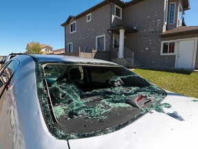 The aftermath of an intense hail storm shows in a damaged home and car in Calgary on Monday, June 15, 2020.