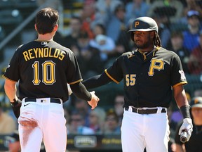 Pittsburgh Pirates left fielder Bryan Reynolds (10) celebrates with first baseman Josh Bell (55) after scoring a run against the Toronto Blue Jays at LECOM Park.