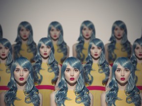 Many Glamour Beauty Woman Clones. Identical Crowd Concept. On Gray Background.