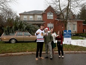 Shawn Turcotte, his wife Chantelle and kids Hudson and Kennedy pose for a photo outside their home. The Turcottes have gone all out this Christmas with a National Lampoon Christmas Vacation themed display.