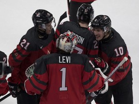 Canada goaltender Devon Levi  celebrates with teammates after Canada defeated Russia 1-0 in IIHF World Junior Hockey Championship pre-competition action on Dec. 23, 2020, in Edmonton.