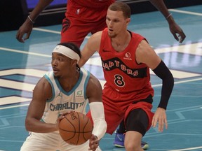 Toronto Raptors guard Malachi Flynn guards Charlotte Hornets guard Devonte' Graham (8) during an NBA preseason game on Dec. 12, 2020 in Charlotte, N.C.
