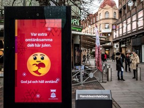 An information sign wishing Merry Christmas and asking to maintain social distancing is seen at a pedestrian shopping street amid the spread of COVID-19 in Helsingborg, Sweden, Dec. 7, 2020.