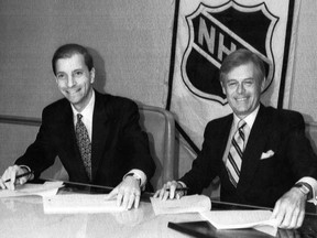 Bruce Firestone, governor of the Ottawa Senators, and National Hockey League President John Ziegler sign an agreement to bring an expansion team to Ottawa on Jan. 14, 1991.